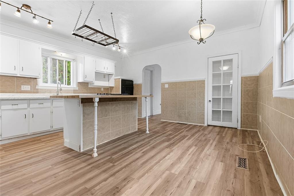 4111 Wildcat Road New Kensington, PA 15068 - Photo 17 of 48 a kitchen with stainless steel appliances granite countertop a sink window and wooden floor