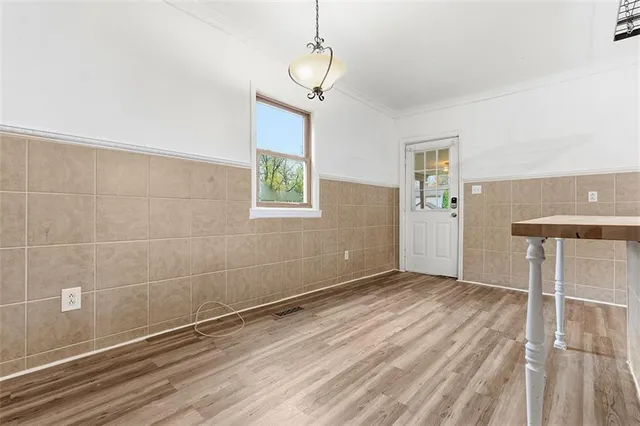 a view of a room with wooden floor and windows