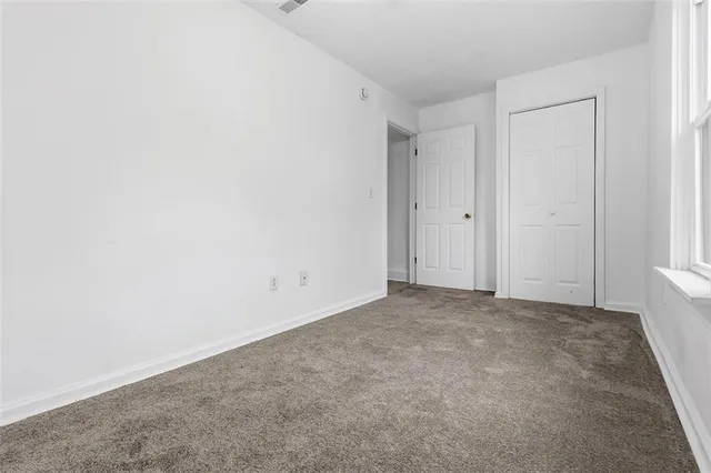a view of an empty room and a window
