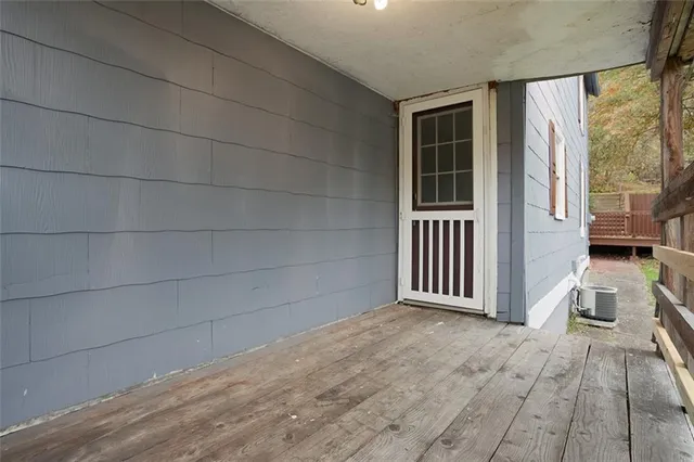 a view of balcony with wooden floor and fence