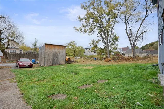 a view of a yard with cars