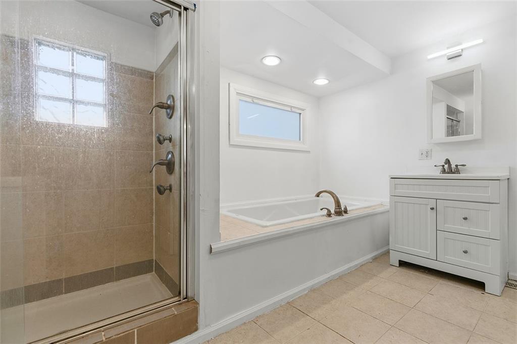 4111 Wildcat Road New Kensington, PA 15068 - Photo 8 of 48 a bathroom with a bathtub a sink a vanity and a shower