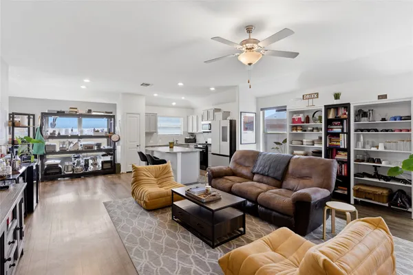 a living room with furniture with kitchen view