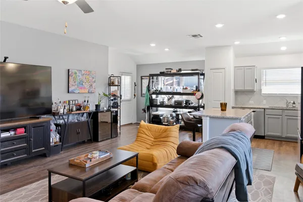 a kitchen with a refrigerator a stove a sink and chairs