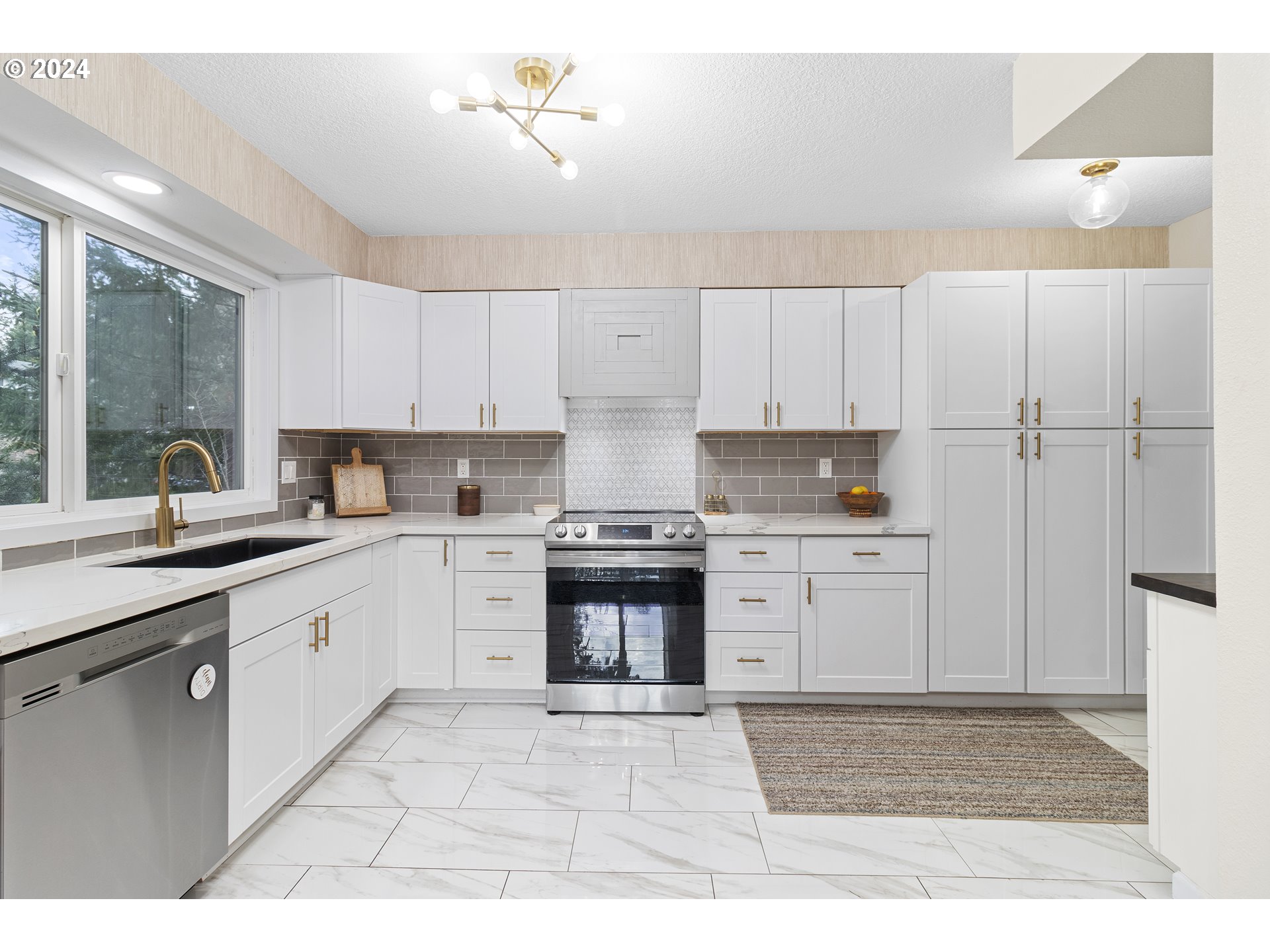 3121 Southwest Orchard Place Gresham, OR 97080 - Photo 16 of 48 a kitchen with granite countertop a stove a sink and a refrigerator