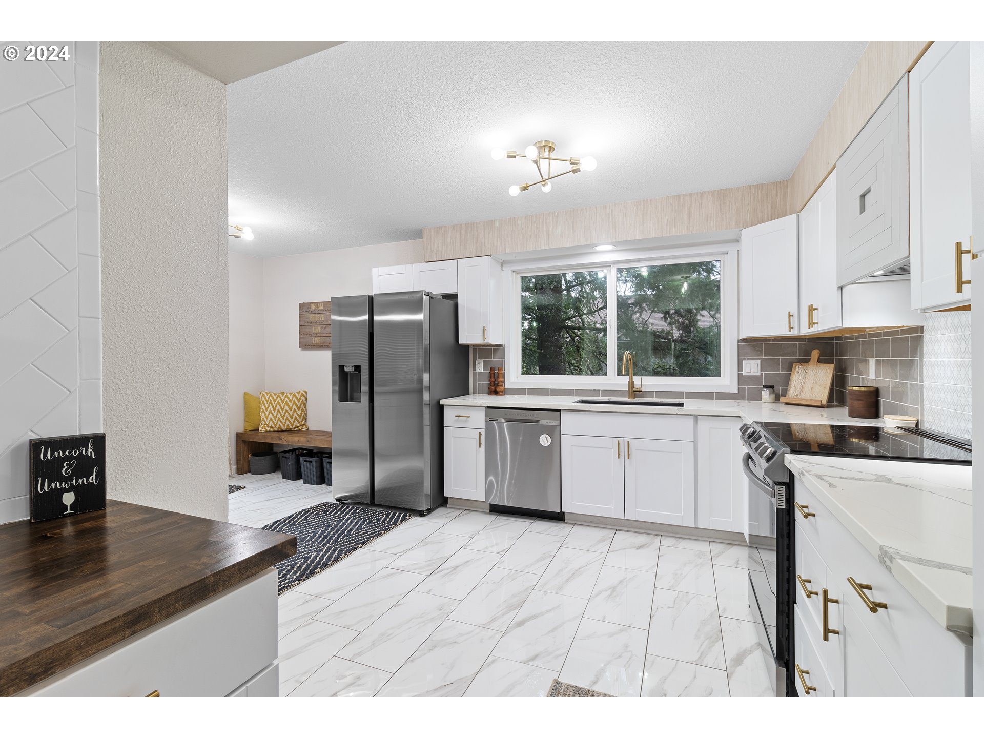 3121 Southwest Orchard Place Gresham, OR 97080 - Photo 18 of 48 a kitchen with stainless steel appliances kitchen island granite countertop a sink cabinets and wooden floor
