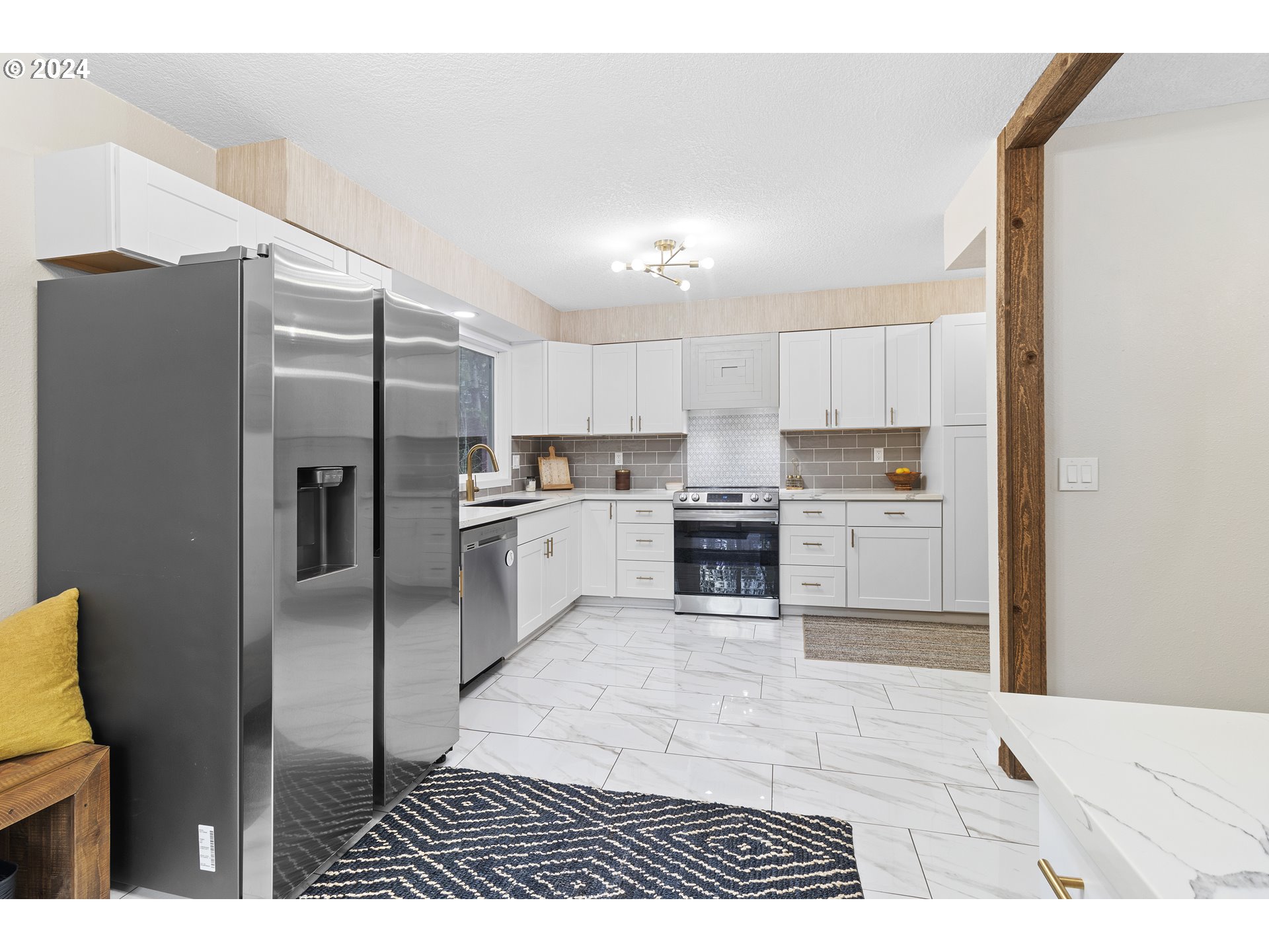 3121 Southwest Orchard Place Gresham, OR 97080 - Photo 20 of 48 a kitchen with stainless steel appliances granite countertop a refrigerator a stove and a sink