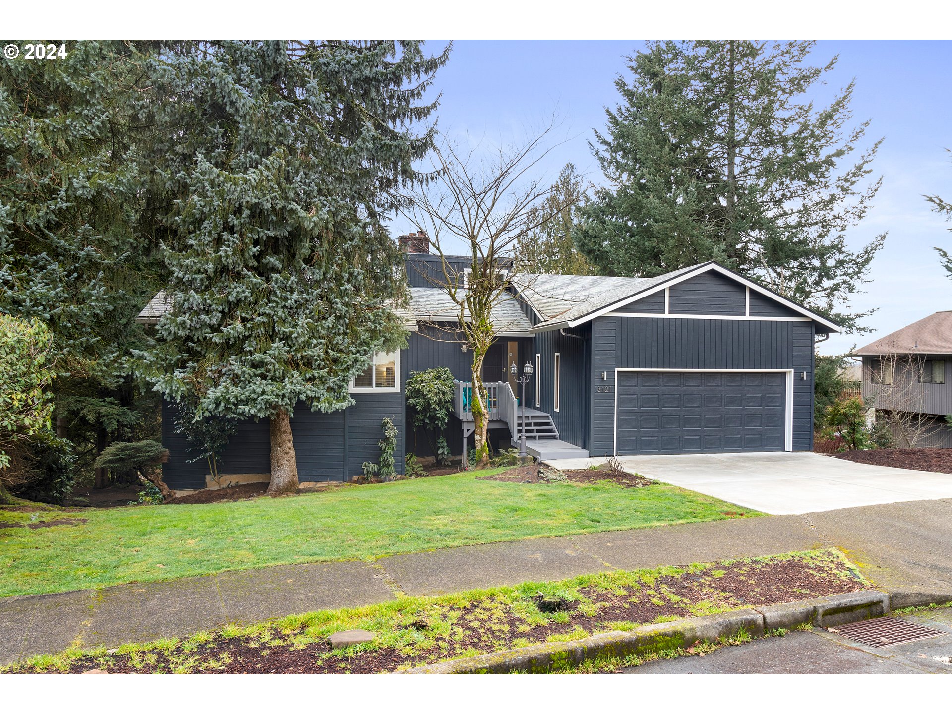 3121 Southwest Orchard Place Gresham, OR 97080 - Photo 2 of 48 a front view of a house with a yard and garage