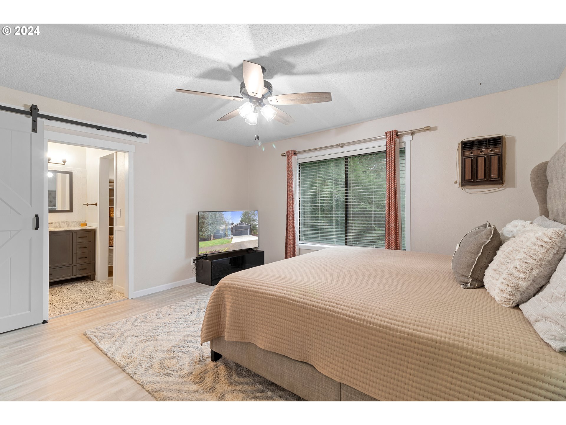 3121 Southwest Orchard Place Gresham, OR 97080 - Photo 23 of 48 a bedroom with a large bed and a large window