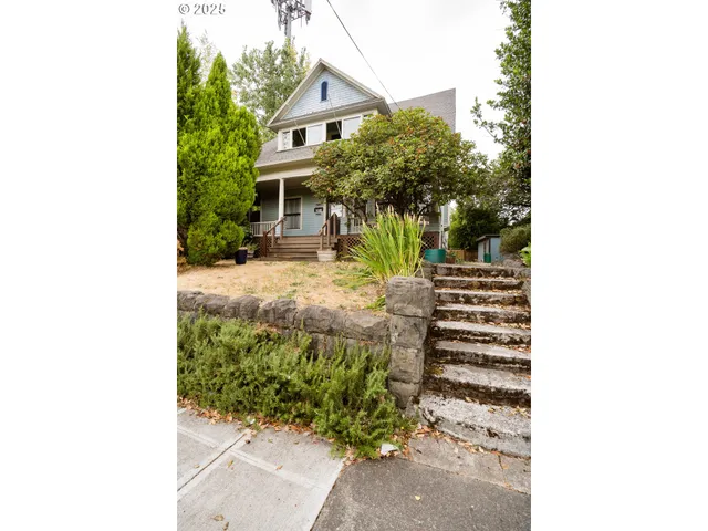 a view of a house with a small yard and plants