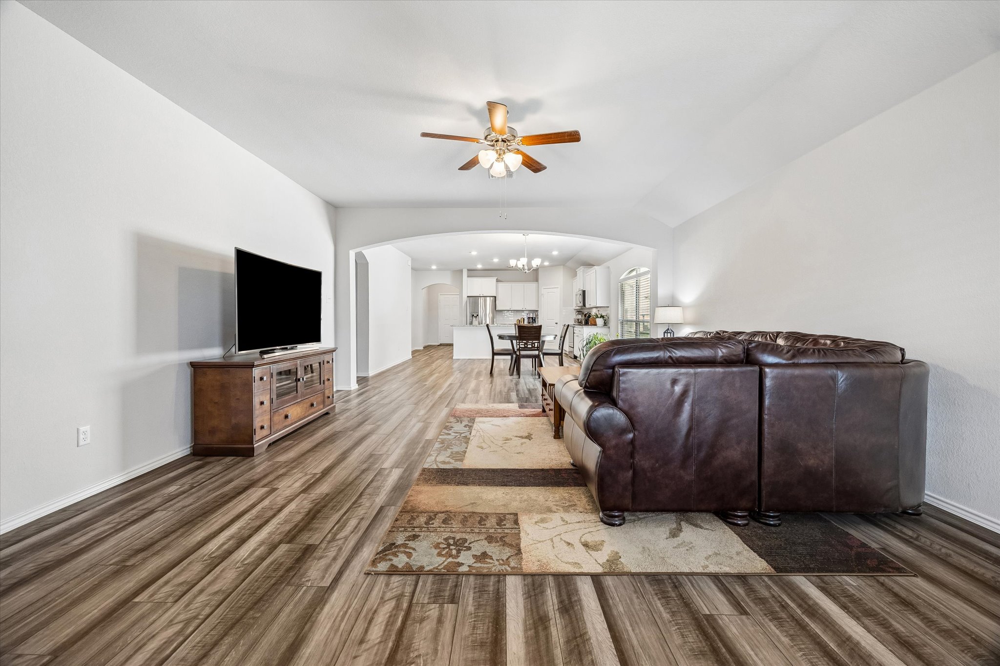 168 Onna Street Taylor, TX 76574 - Photo 12 of 30 a living room with a couch and a flat screen tv