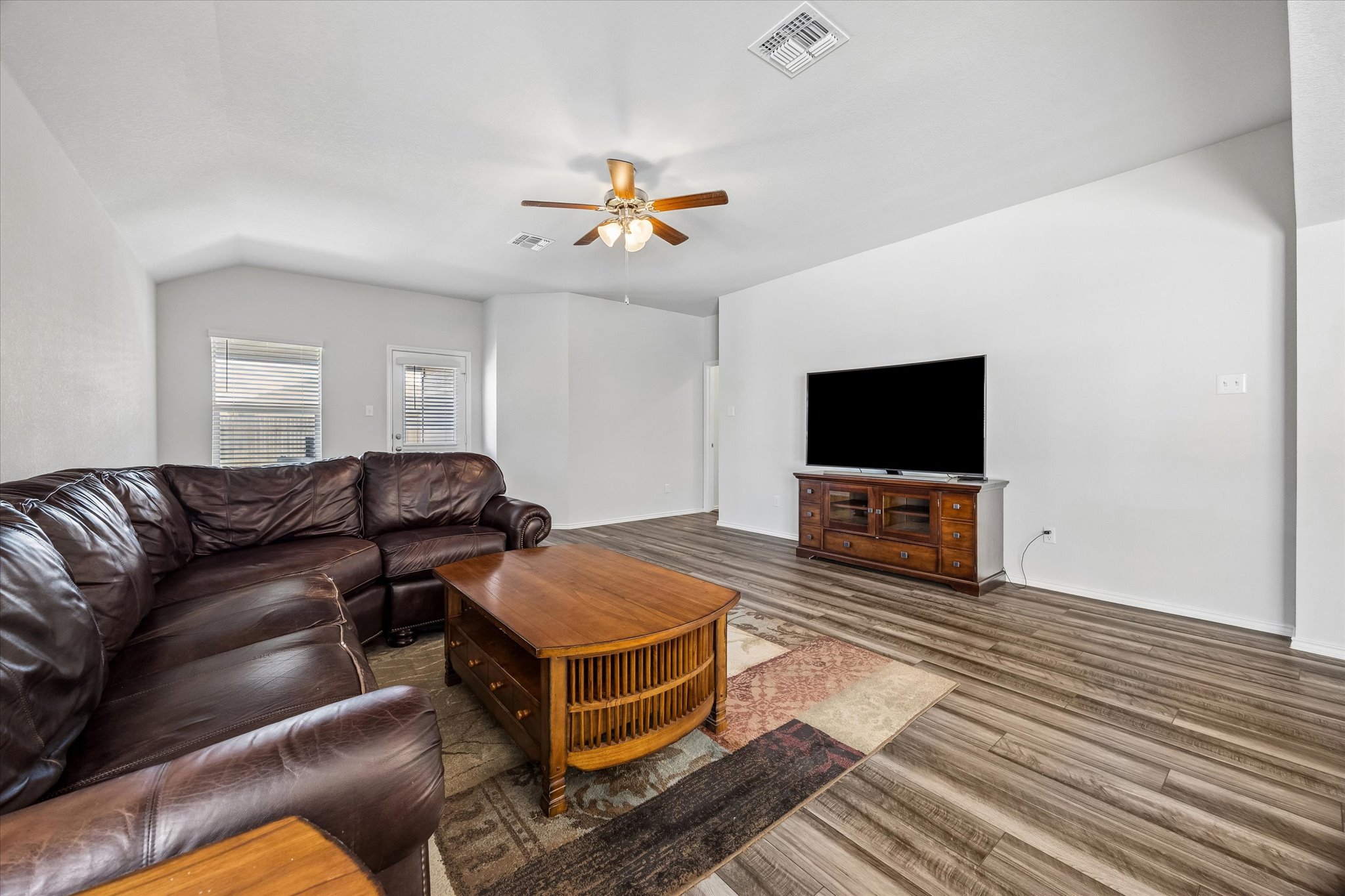 168 Onna Street Taylor, TX 76574 - Photo 13 of 30 a living room with furniture and a flat screen tv