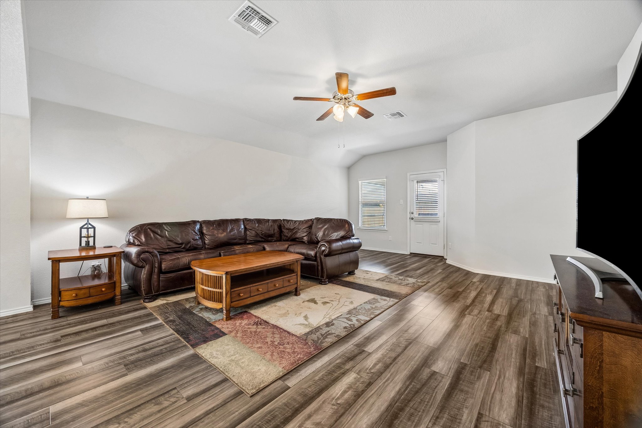 168 Onna Street Taylor, TX 76574 - Photo 14 of 30 a bedroom with a bed and a chandelier
