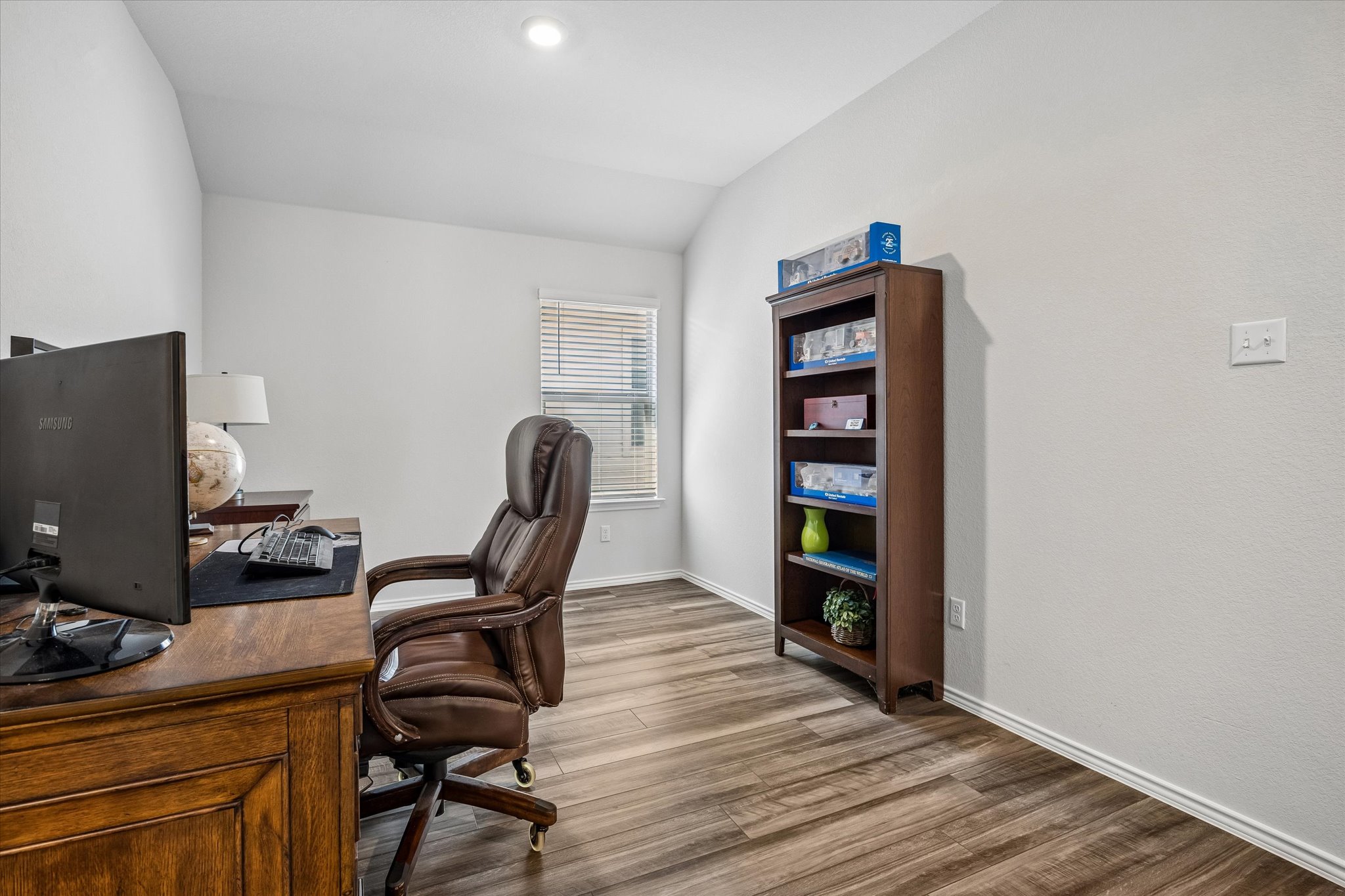 168 Onna Street Taylor, TX 76574 - Photo 17 of 30 a view of a workspace with furniture and wooden floor