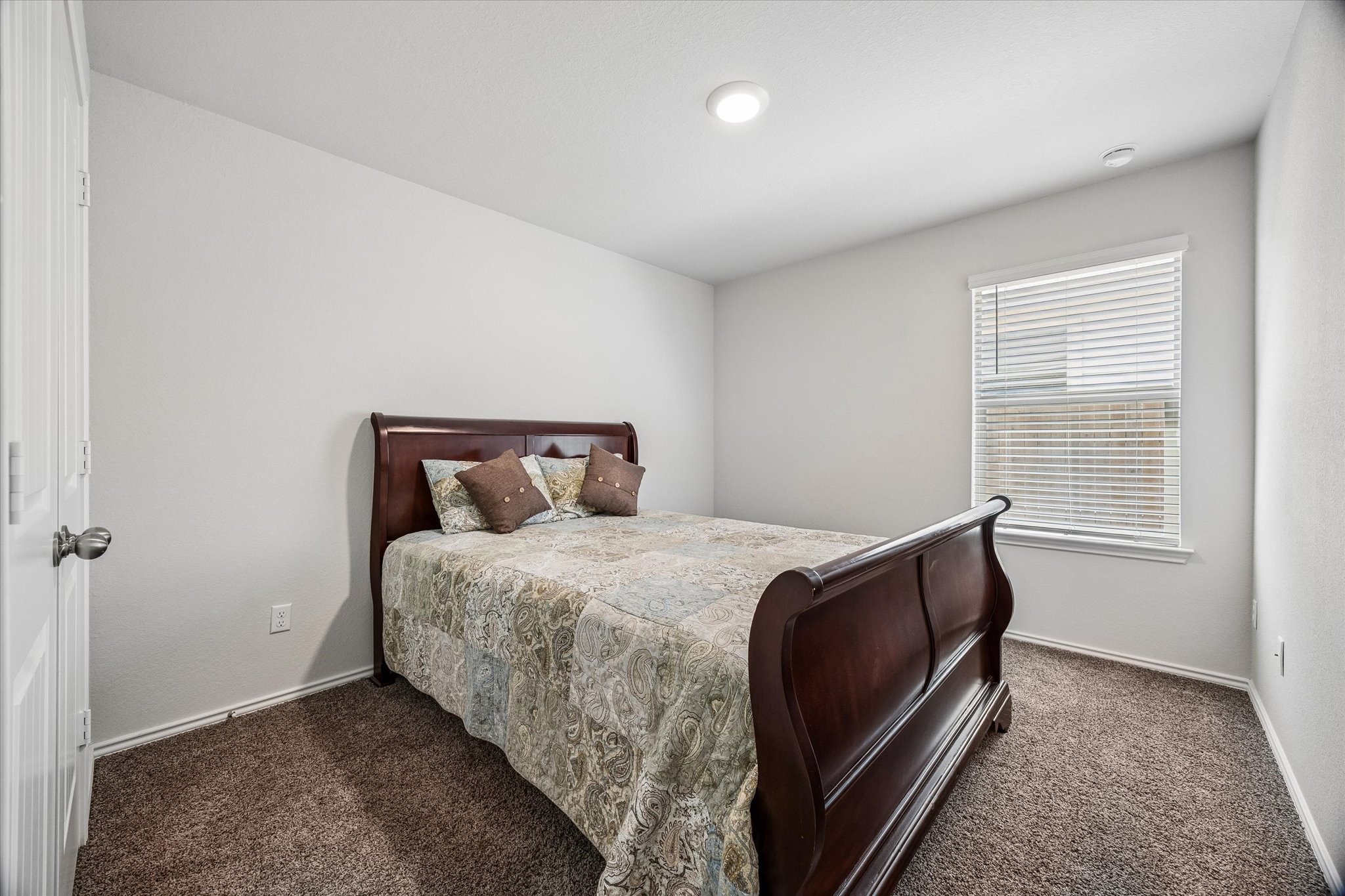 168 Onna Street Taylor, TX 76574 - Photo 18 of 30 a bedroom with a bed and a window