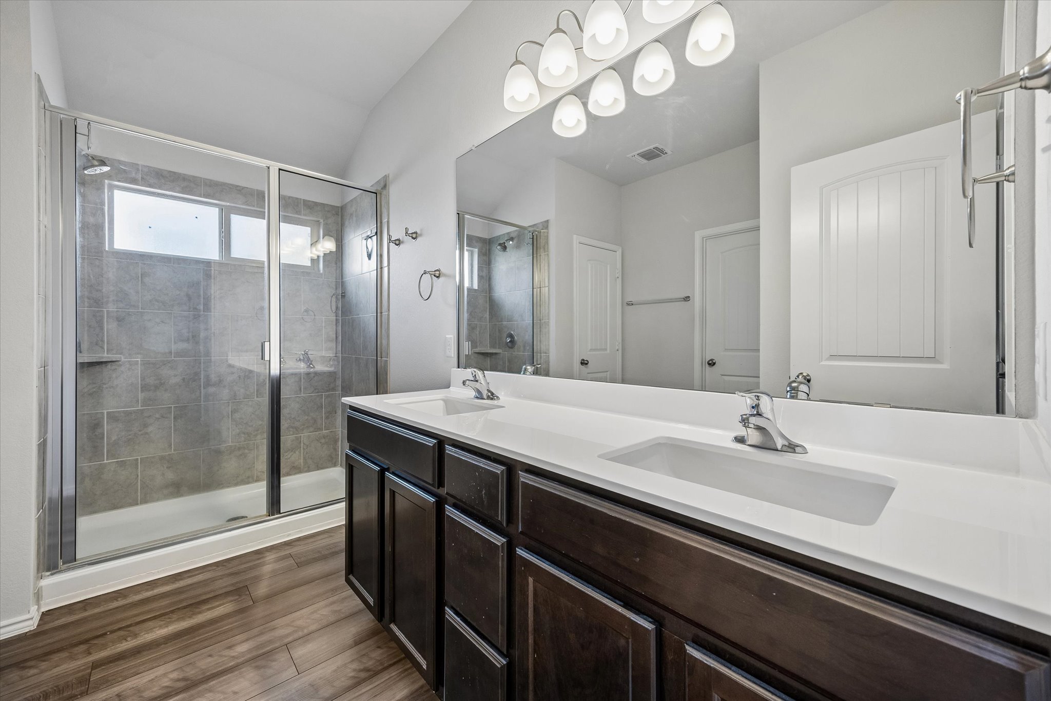 168 Onna Street Taylor, TX 76574 - Photo 19 of 30 a bathroom with a double vanity sink mirror and shower