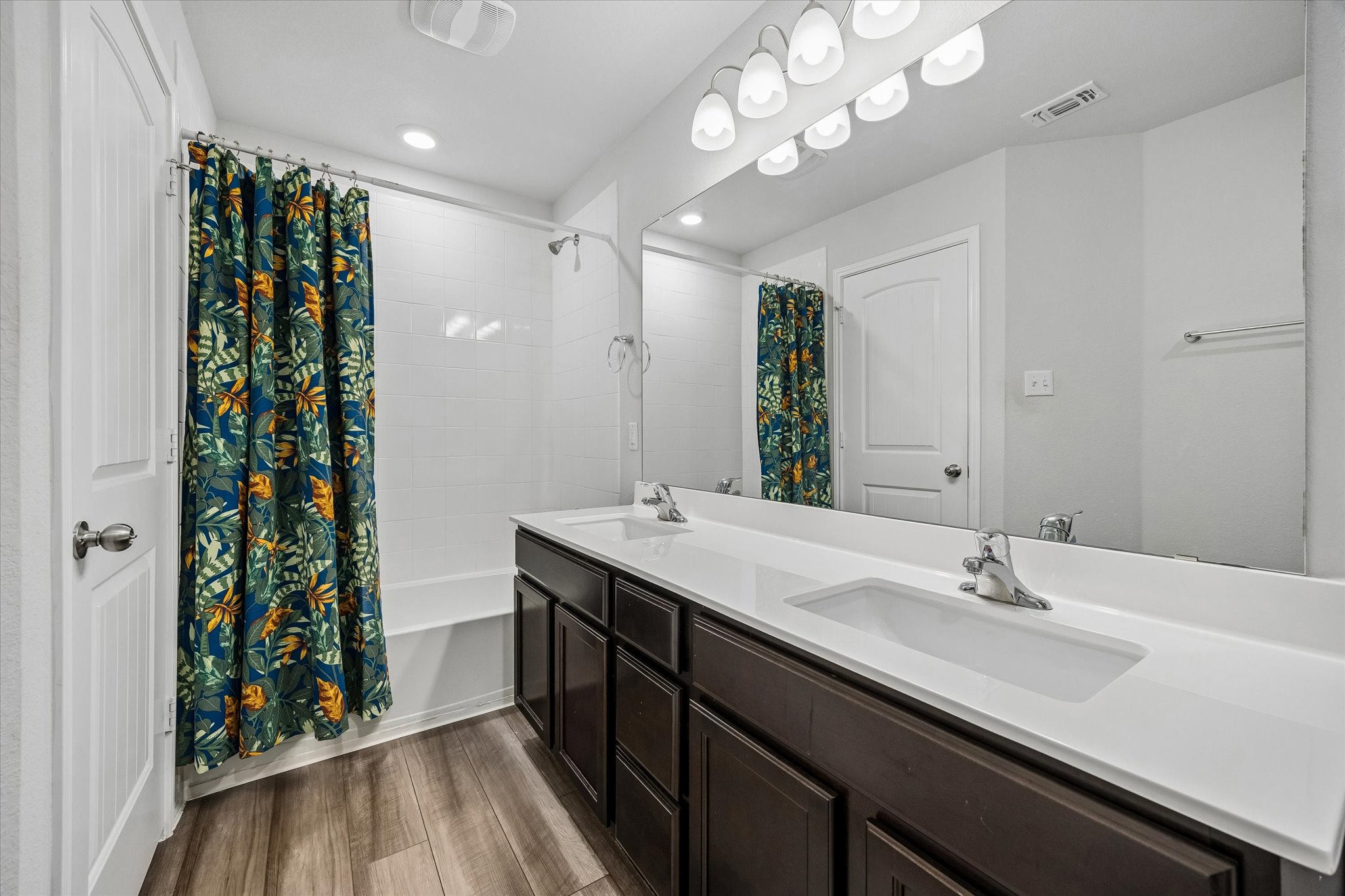 168 Onna Street Taylor, TX 76574 - Photo 22 of 30 a bathroom with a double vanity sink and a mirror