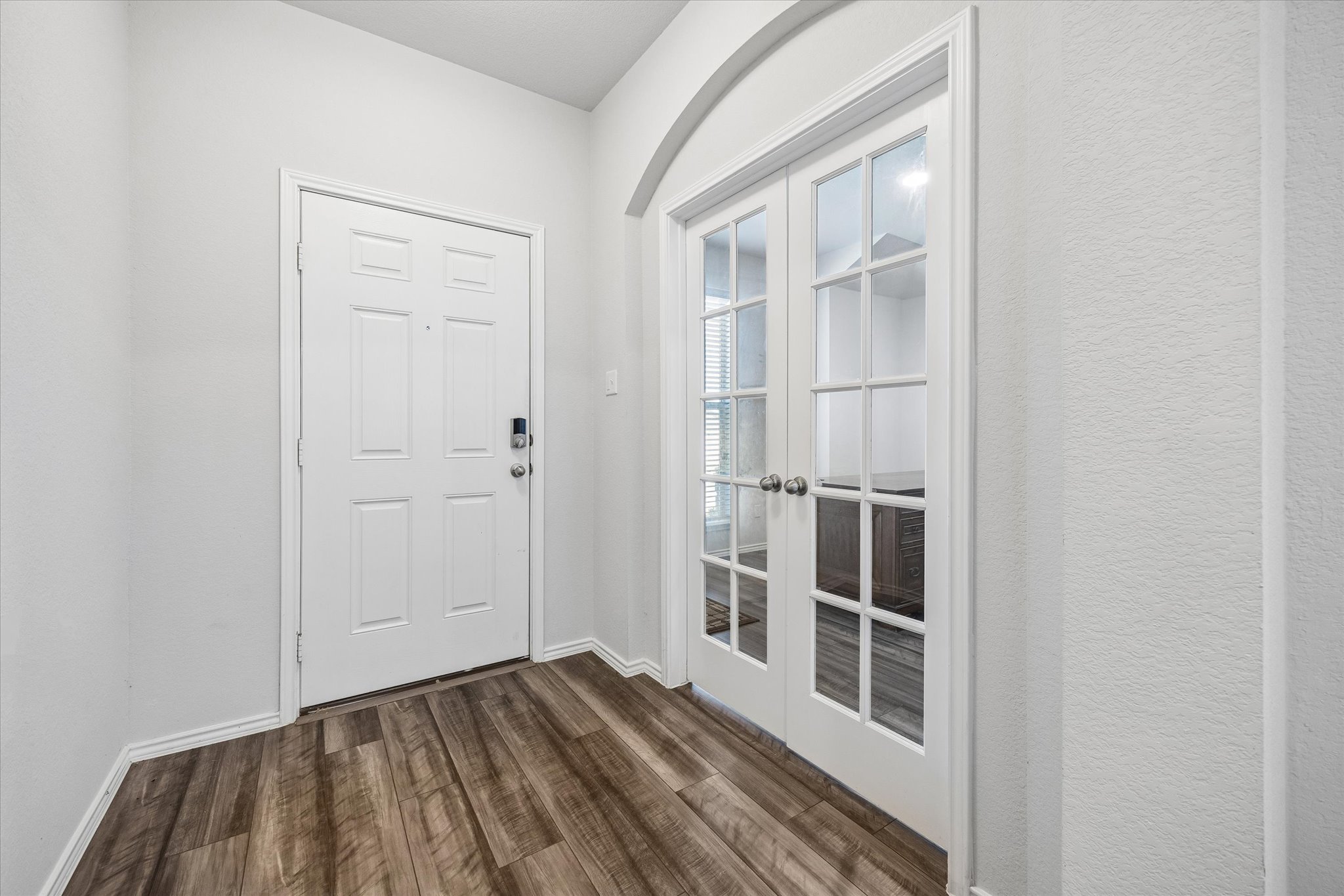 168 Onna Street Taylor, TX 76574 - Photo 4 of 30 a view of a hallway with wooden floor and entryway