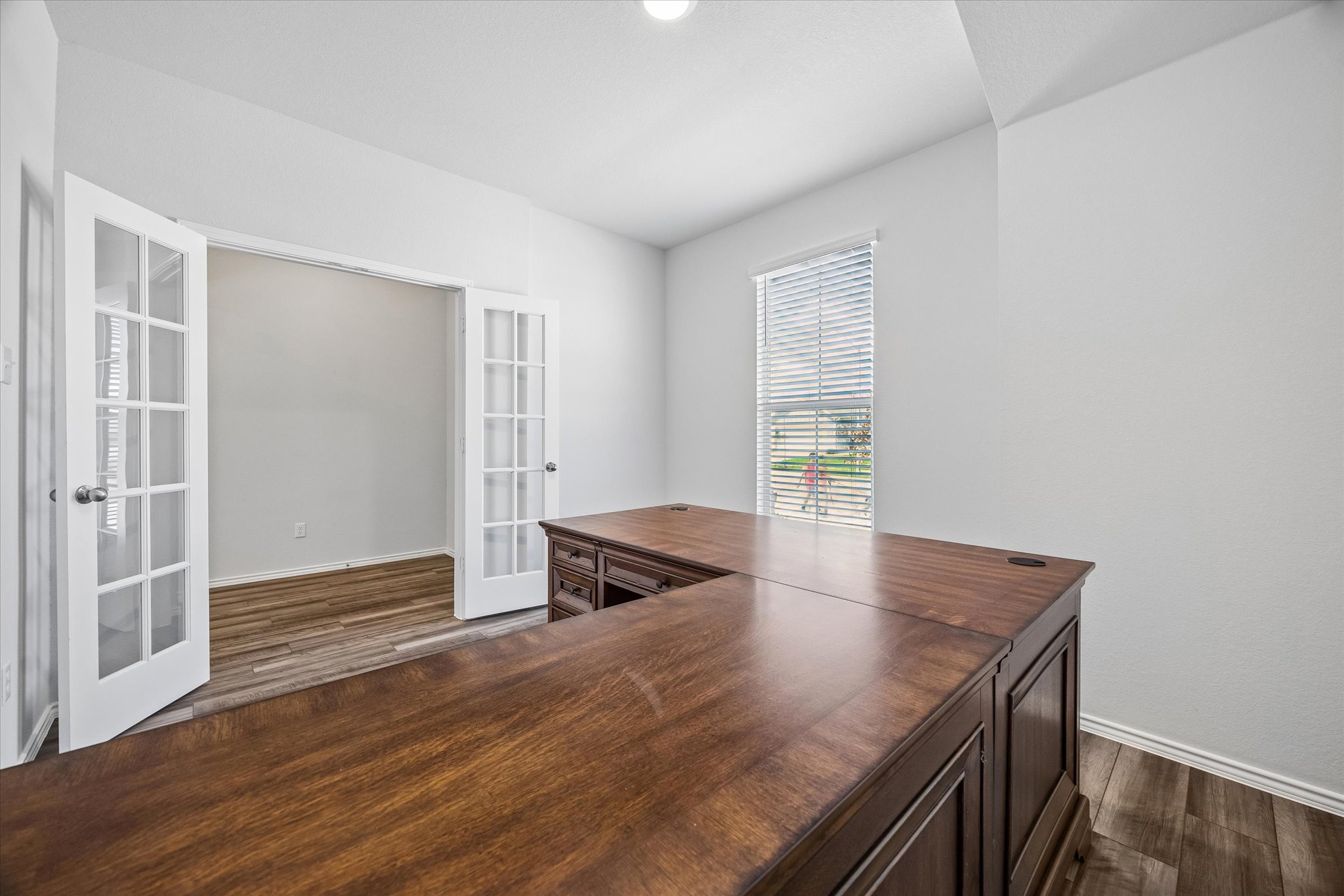 168 Onna Street Taylor, TX 76574 - Photo 6 of 30 an empty room with wooden floor and windows