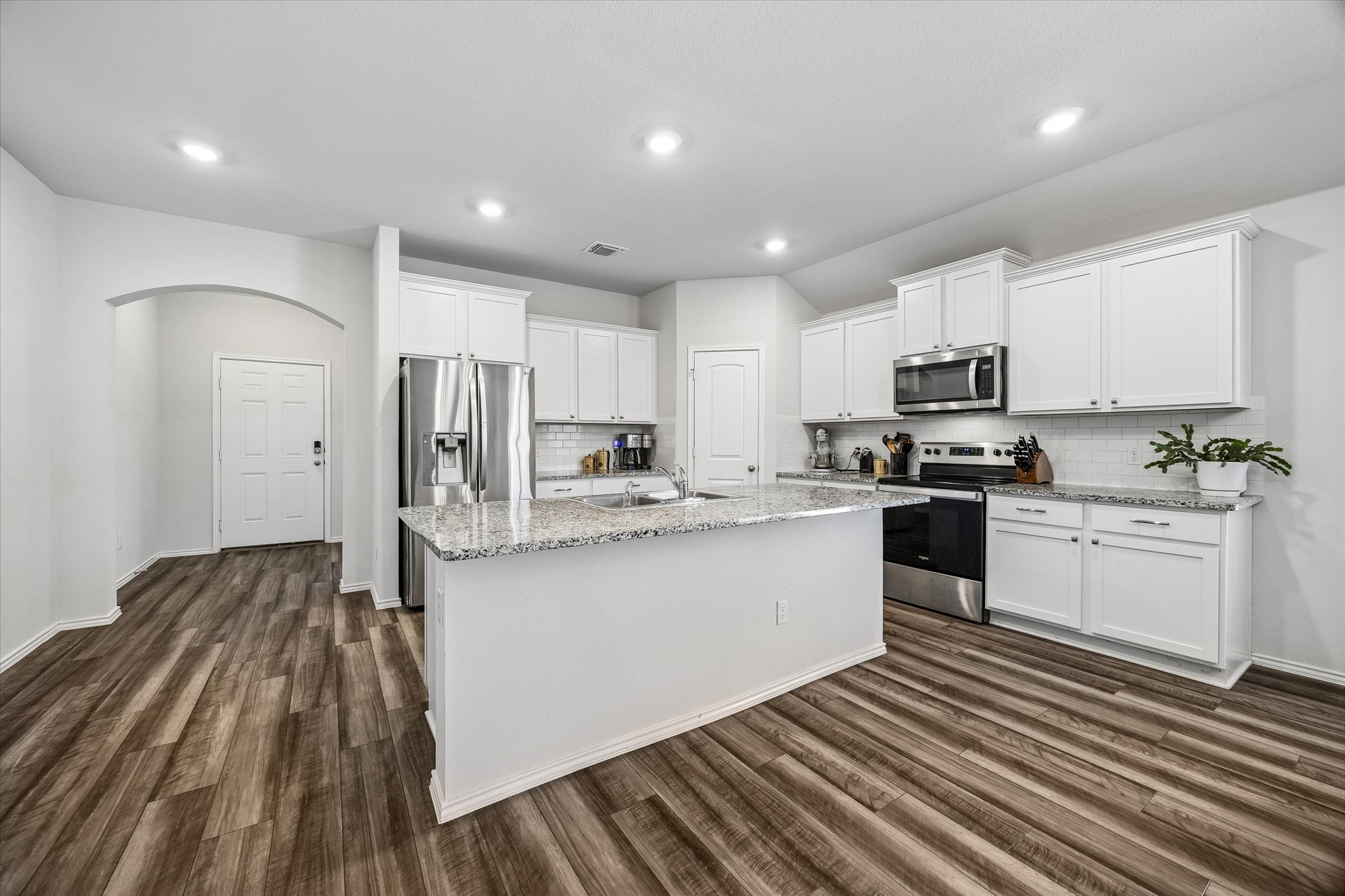 168 Onna Street Taylor, TX 76574 - Photo 8 of 30 a kitchen with stainless steel appliances a refrigerator sink and microwave