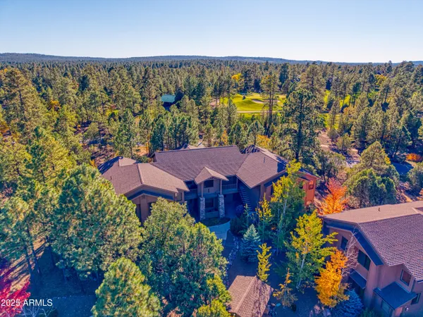 an aerial view of a house with a swimming pool yard and outdoor seating