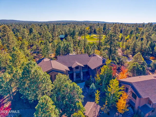 an aerial view of a house with a swimming pool yard and outdoor seating
