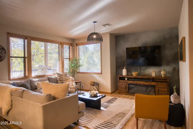 a view of a patio with table and chairs under an umbrella