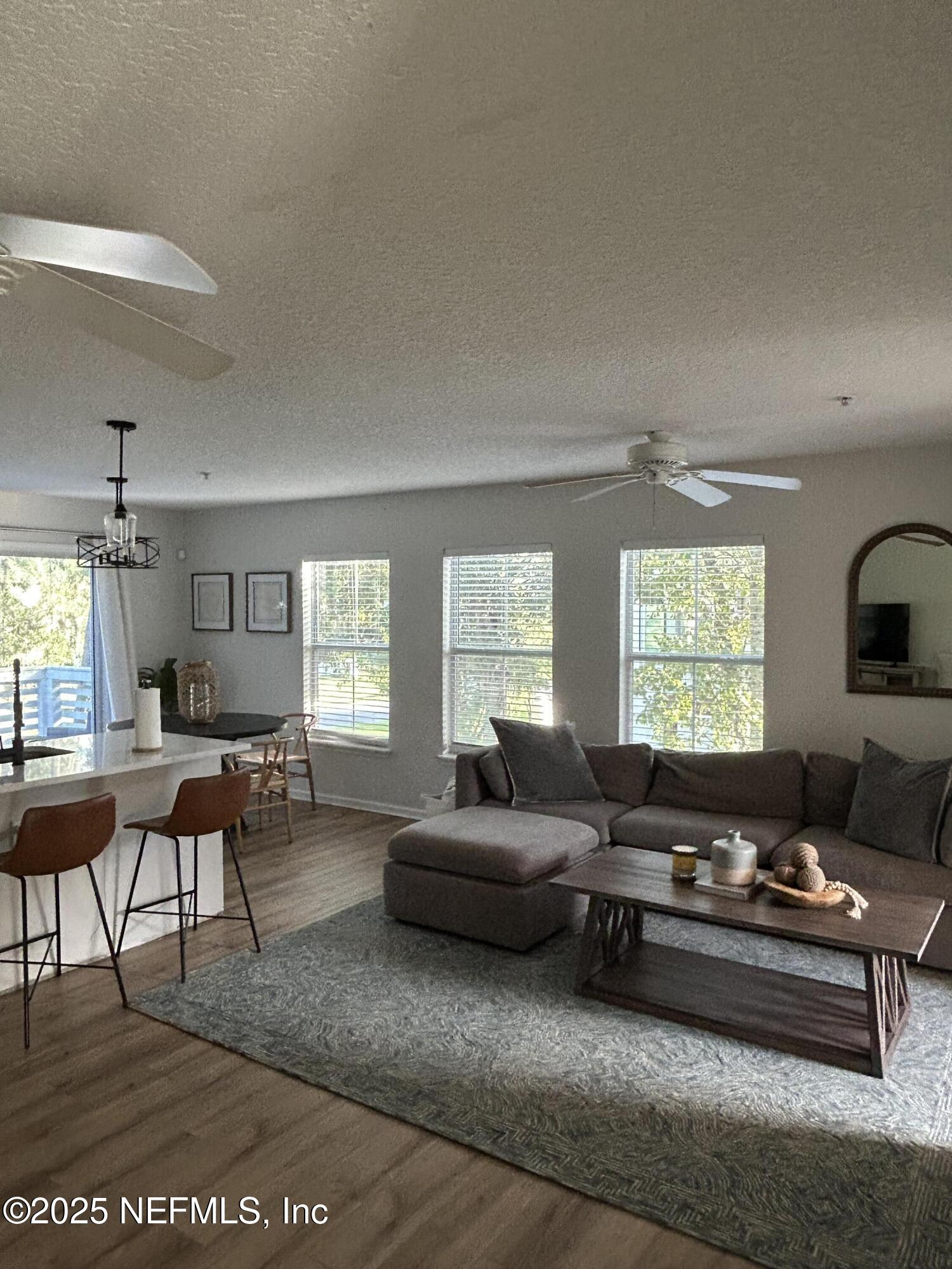 2102 Marsh Point Road, Unit 2102 Neptune Beach, FL 32266 - Photo 11 of 20 a living room with furniture and a large window