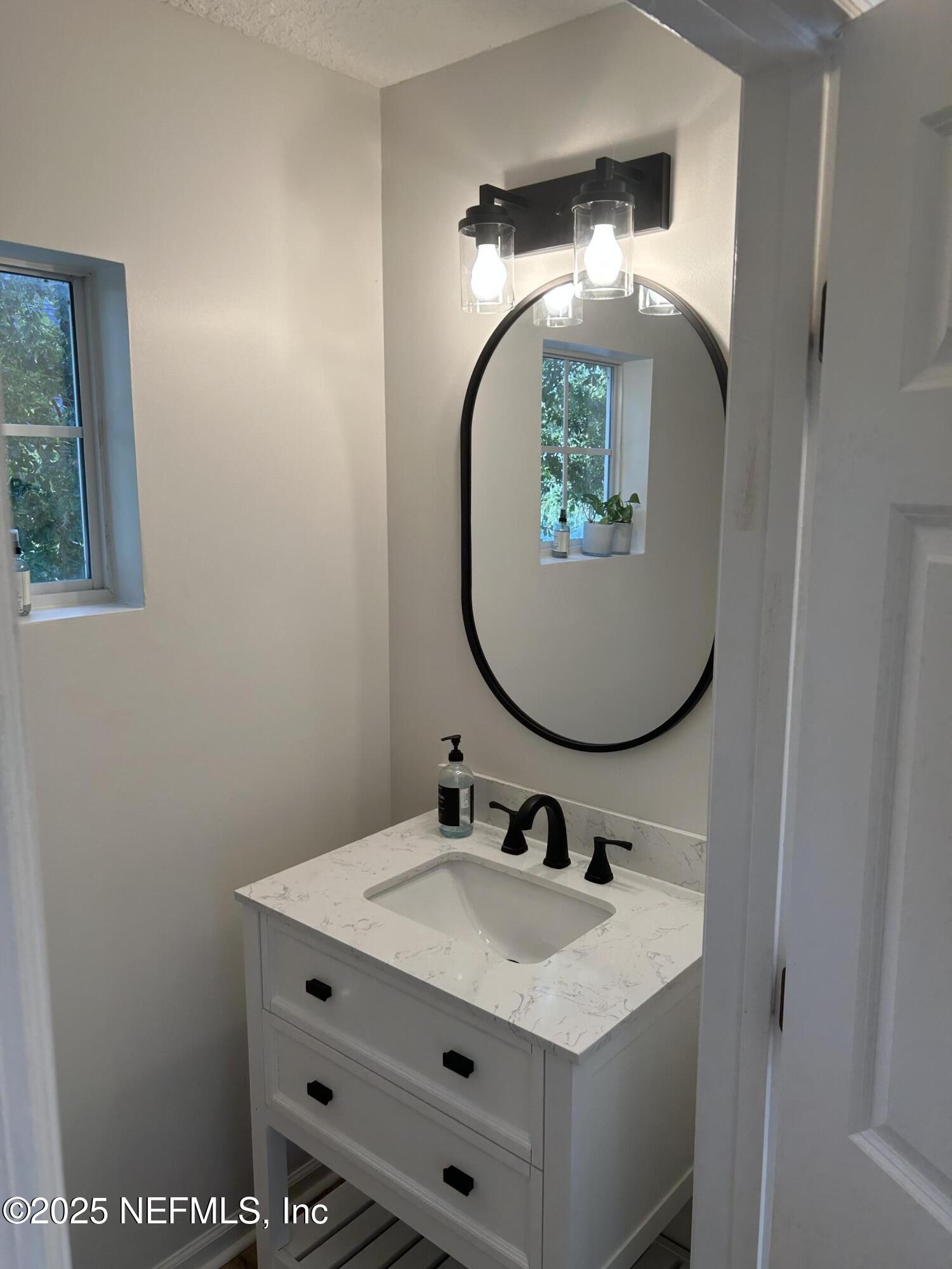 2102 Marsh Point Road, Unit 2102 Neptune Beach, FL 32266 - Photo 8 of 20 a bathroom with a sink and a mirror