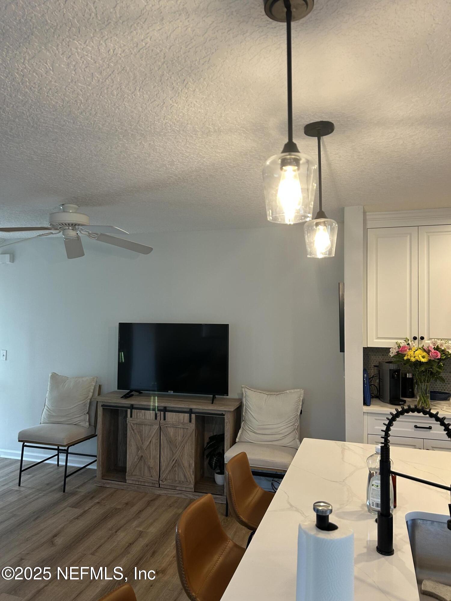 2102 Marsh Point Road, Unit 2102 Neptune Beach, FL 32266 - Photo 10 of 20 a living room with furniture and a flat screen tv