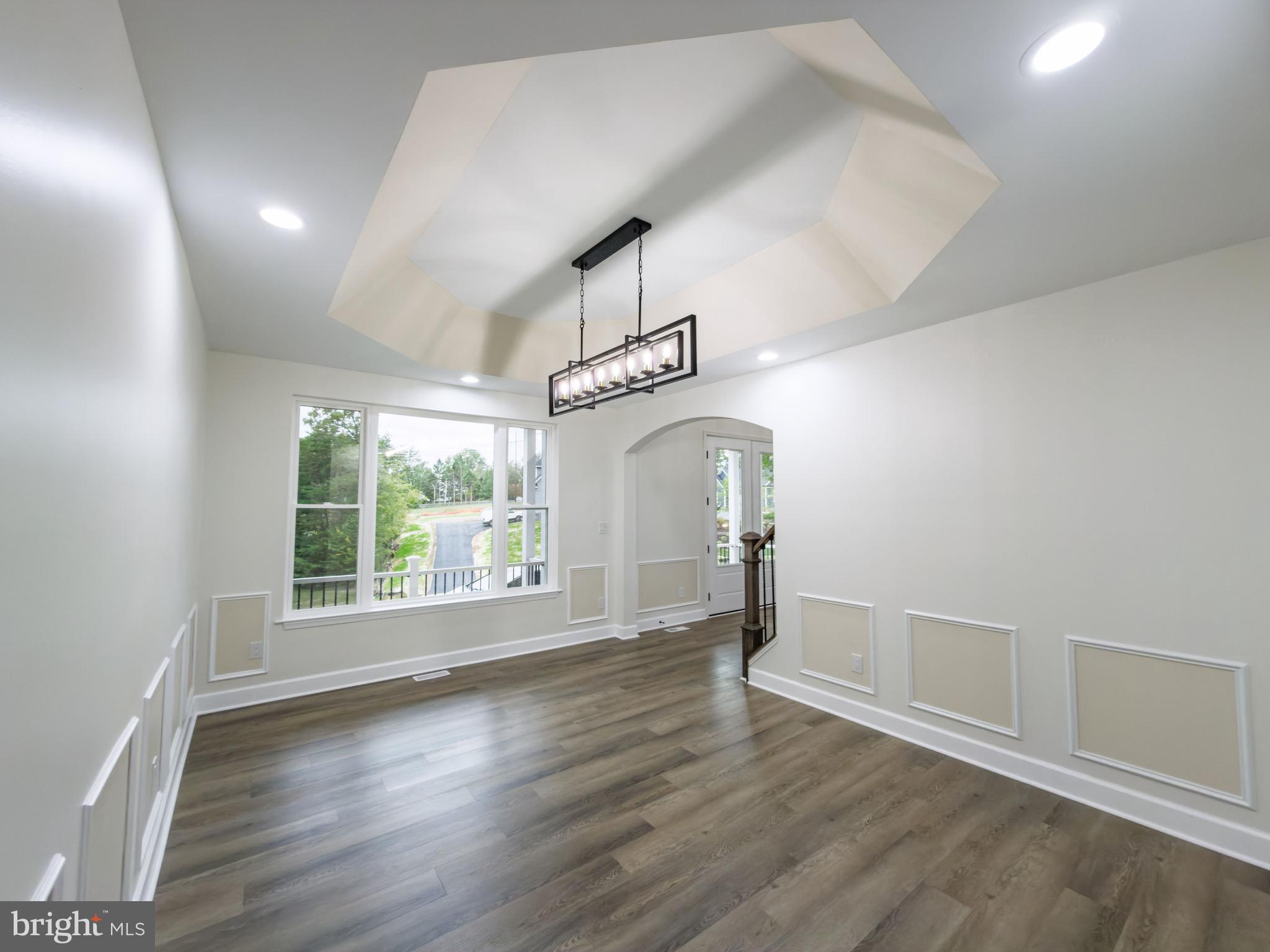 10401 Laurel Ridge Way Fredericksburg, VA 22408 - Photo 13 of 49 an empty room with wooden floor and windows