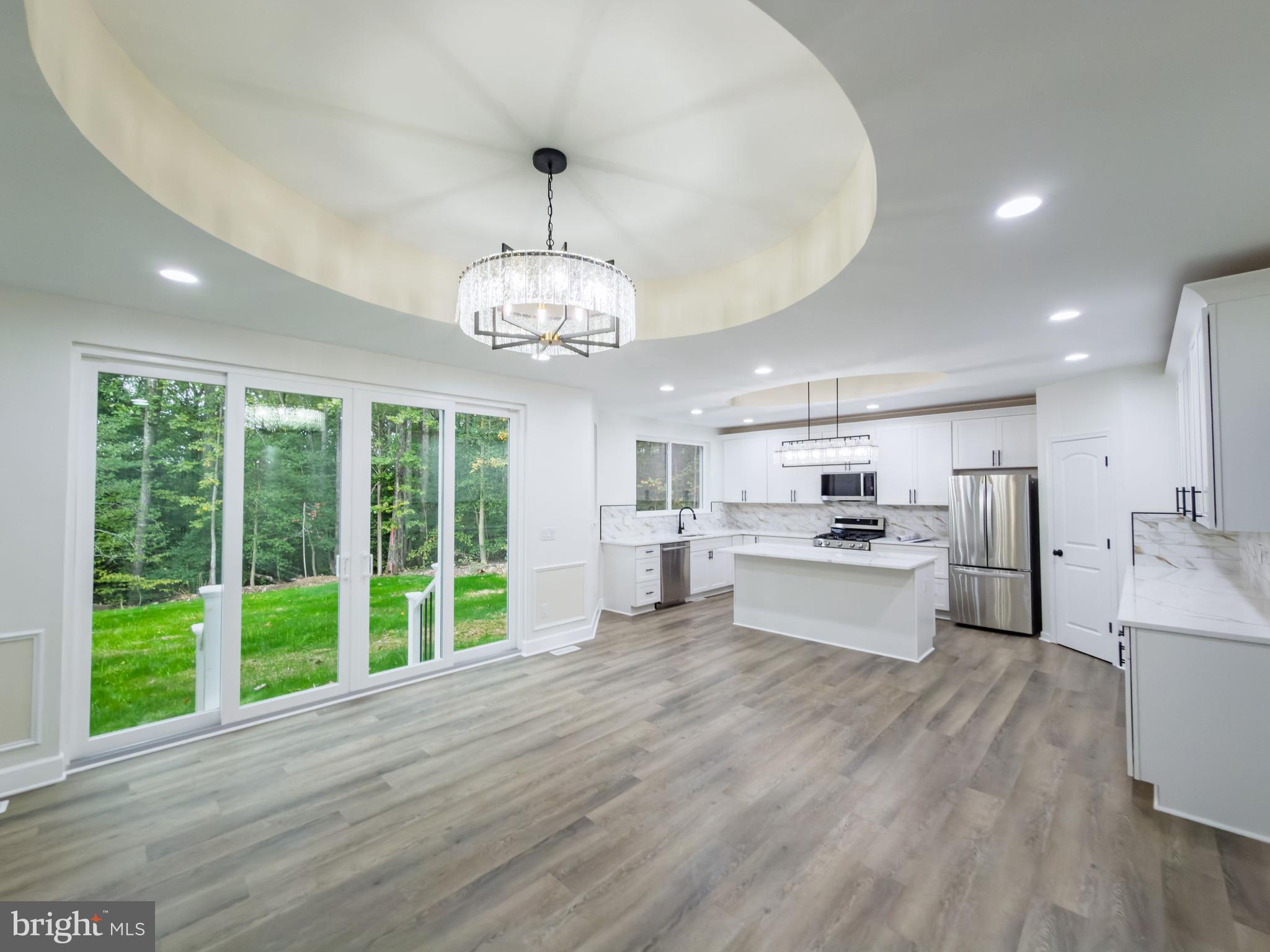 10401 Laurel Ridge Way Fredericksburg, VA 22408 - Photo 14 of 49 a view of a kitchen with kitchen island a large counter space a sink appliances and a counter top space