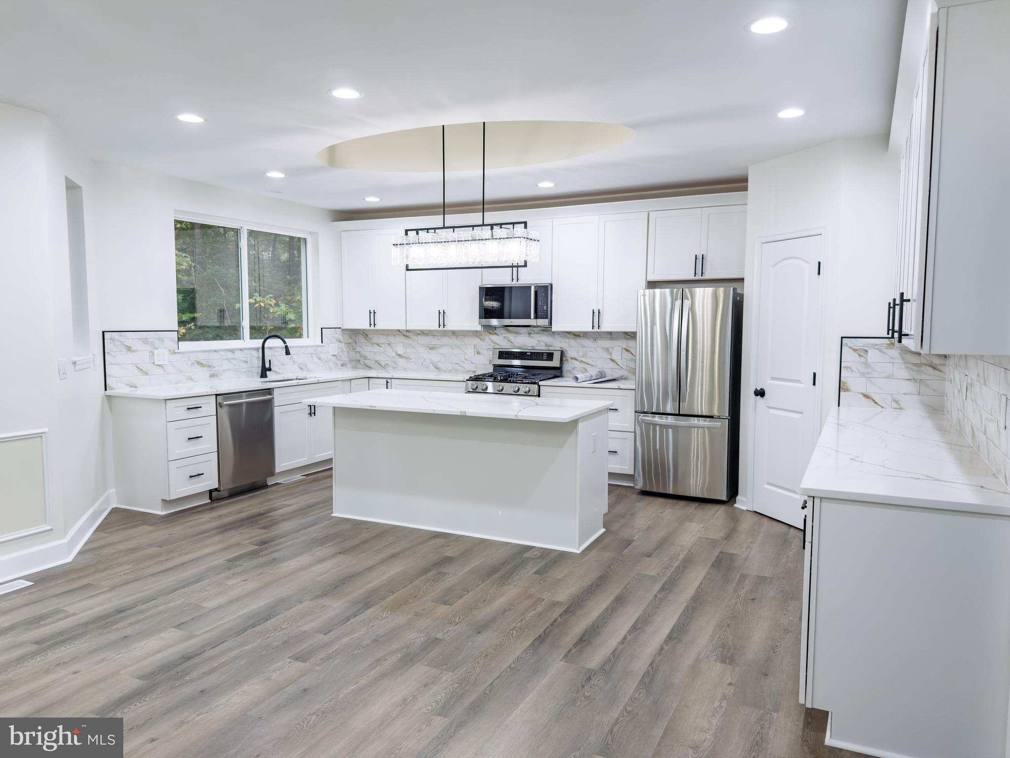 10401 Laurel Ridge Way Fredericksburg, VA 22408 - Photo 15 of 49 a kitchen with stainless steel appliances a refrigerator a stove a sink and white cabinets