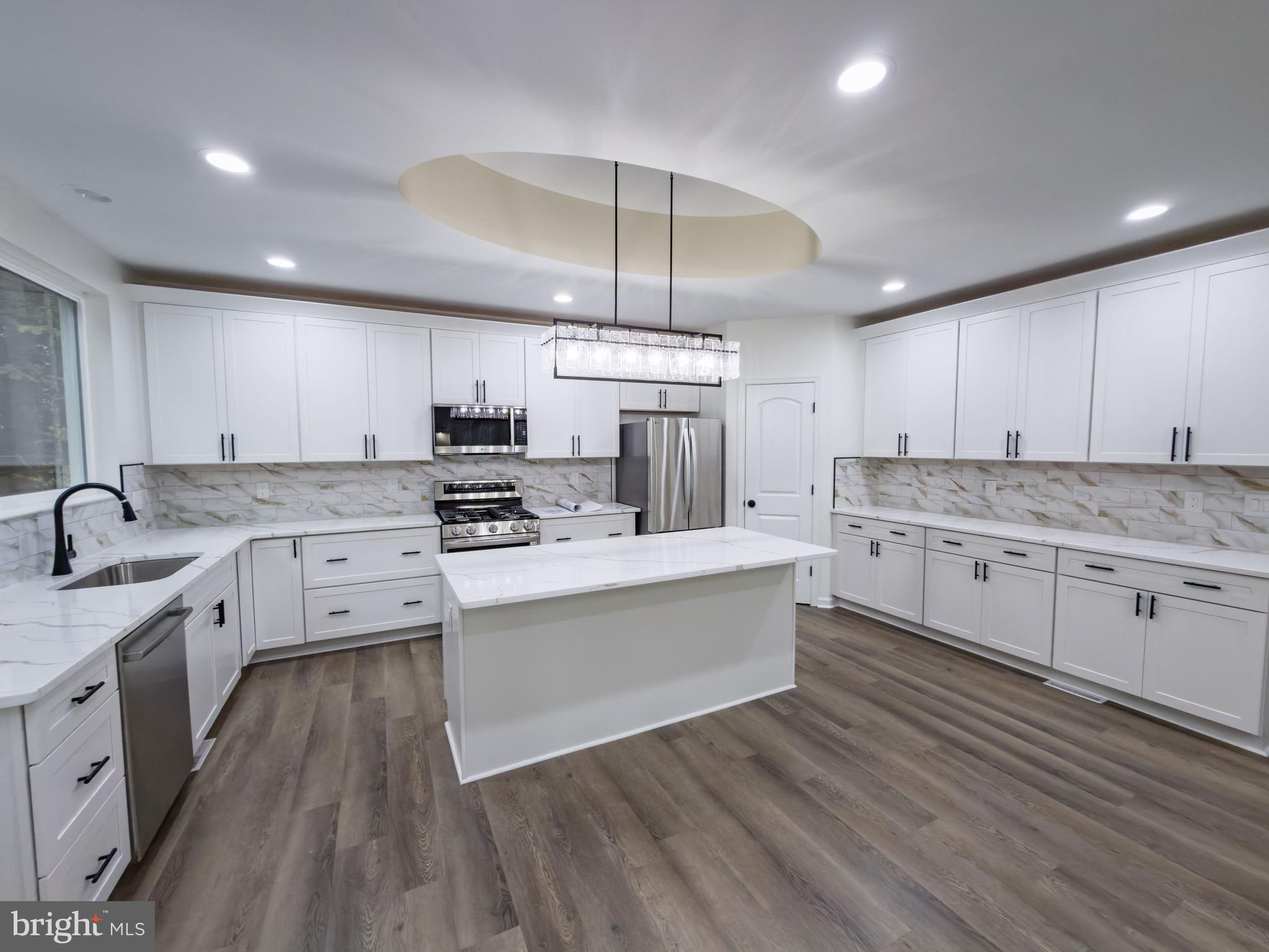 10401 Laurel Ridge Way Fredericksburg, VA 22408 - Photo 16 of 49 a kitchen with stainless steel appliances granite countertop a stove a sink dishwasher and a refrigerator with wooden floor