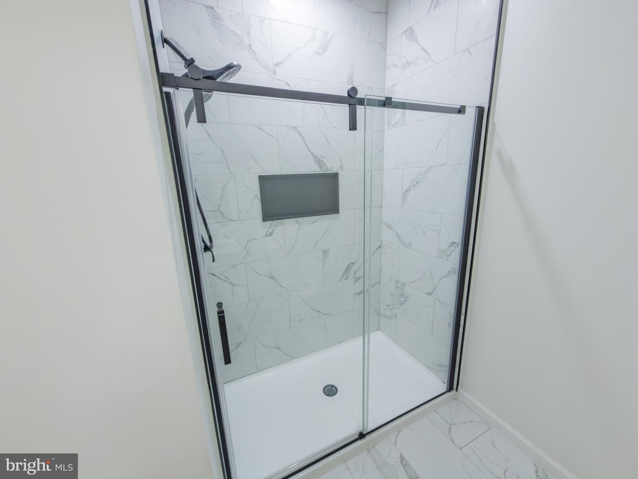10401 Laurel Ridge Way Fredericksburg, VA 22408 - Photo 20 of 49 a bathroom with a glass shower door