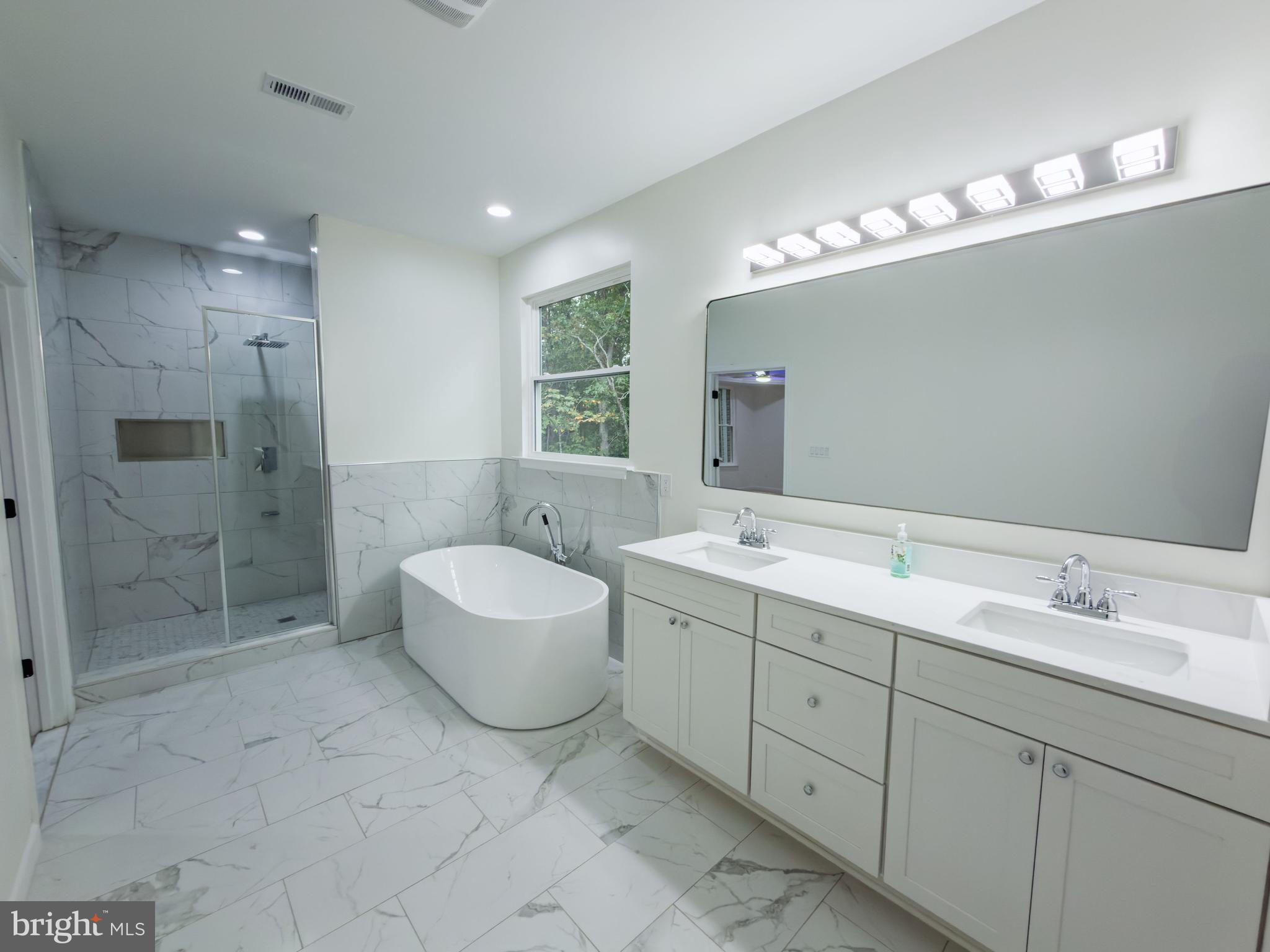 10401 Laurel Ridge Way Fredericksburg, VA 22408 - Photo 26 of 49 a spacious bathroom with double sink a toilet a shower and a mirror