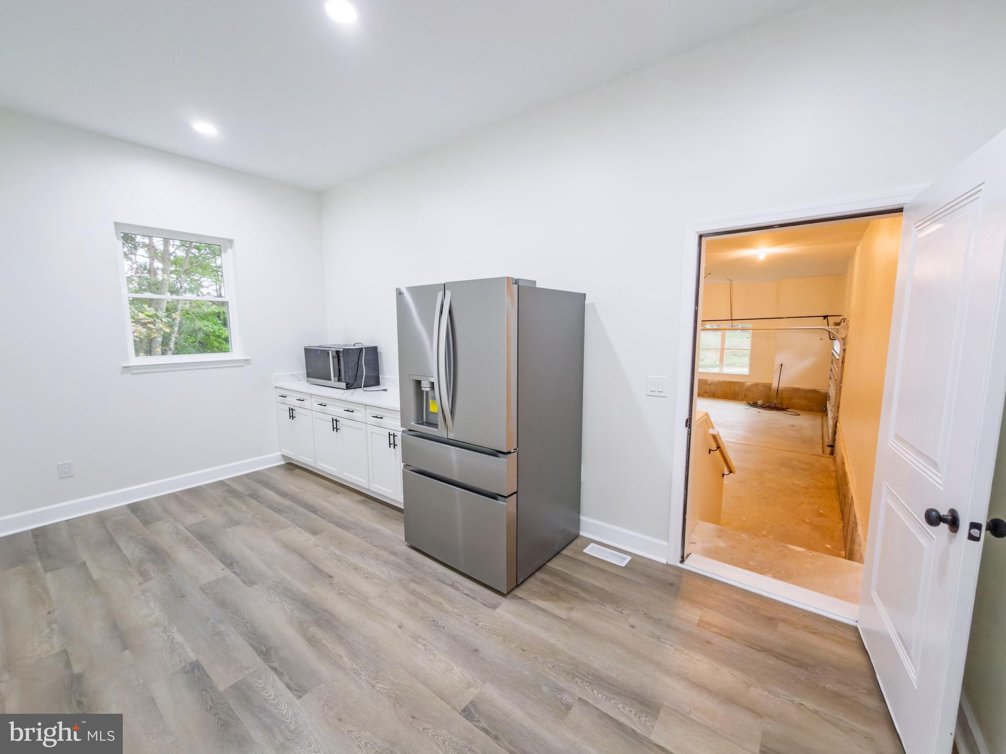 10401 Laurel Ridge Way Fredericksburg, VA 22408 - Photo 38 of 49 a kitchen with stainless steel appliances a refrigerator and a wooden floor