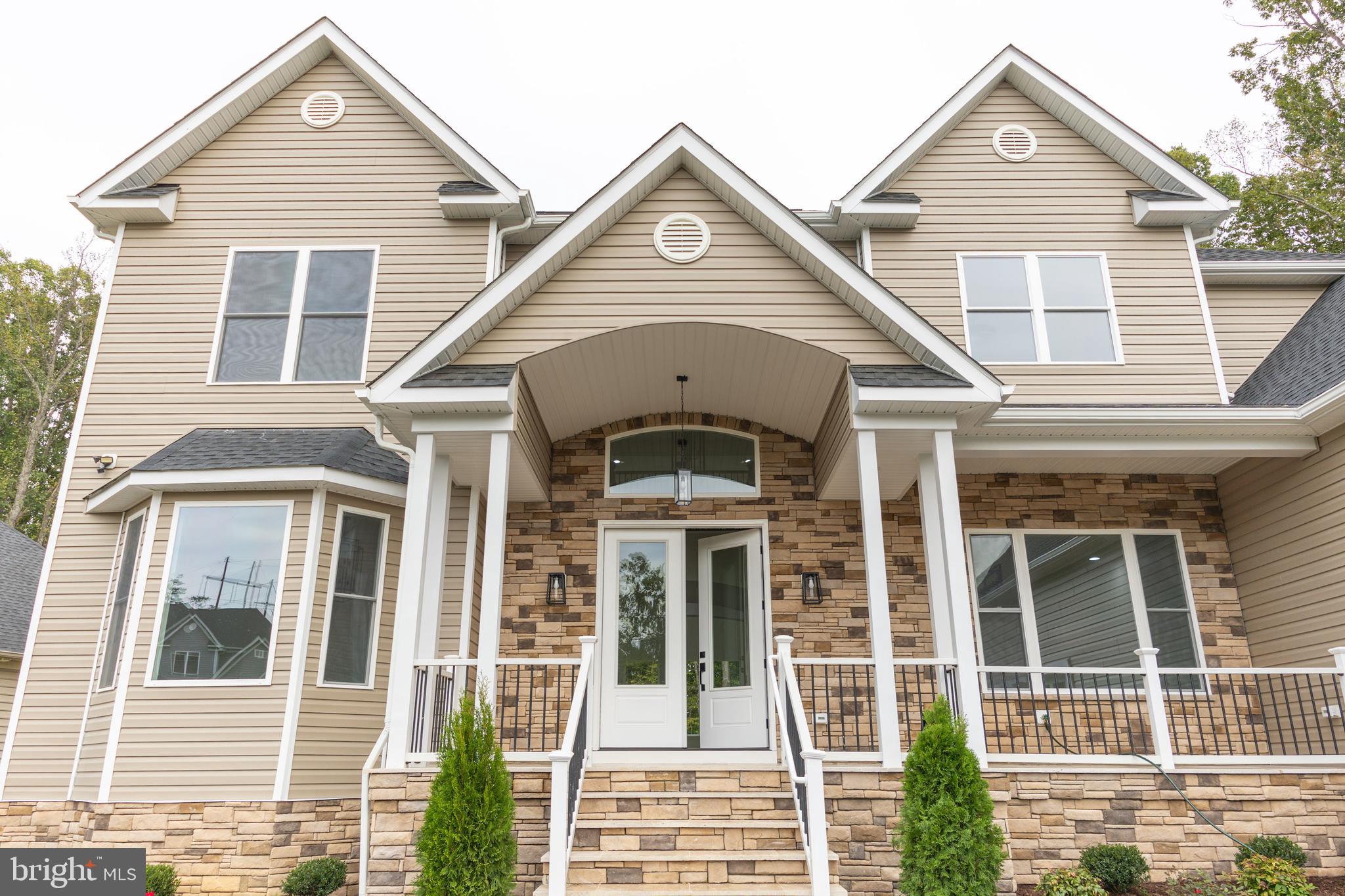 10401 Laurel Ridge Way Fredericksburg, VA 22408 - Photo 5 of 49 a front view of a house with a yard