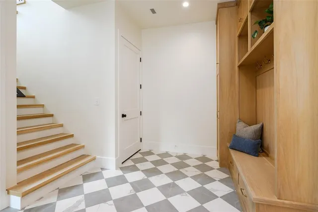 a view of a bedroom with wooden floor and white walls