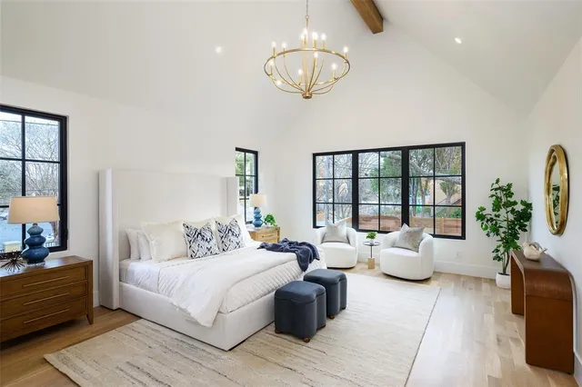 a living room with furniture potted plant and a large window