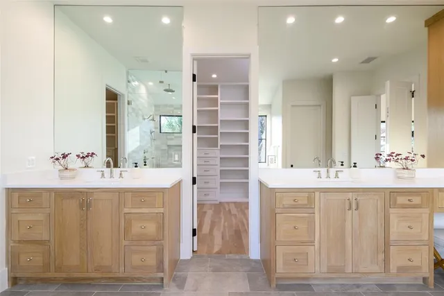 a bathroom with a double vanity sink and a mirror