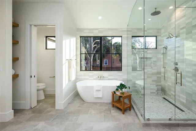 a spacious bathroom with a bathtub and shower