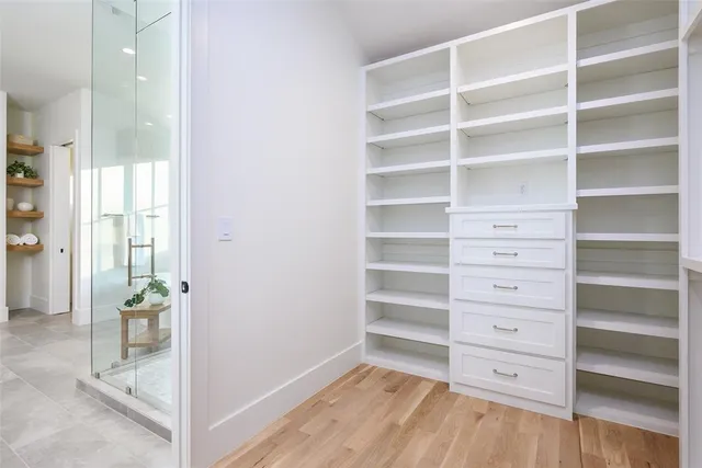 a view of walk in closet with empty racks