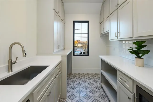 a kitchen with a sink and cabinets