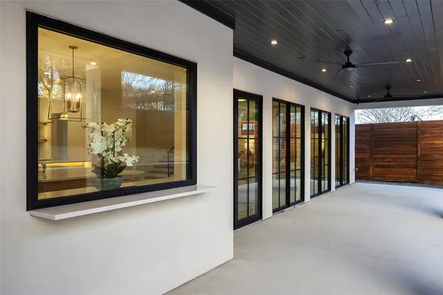 a view of a hallway with large windows