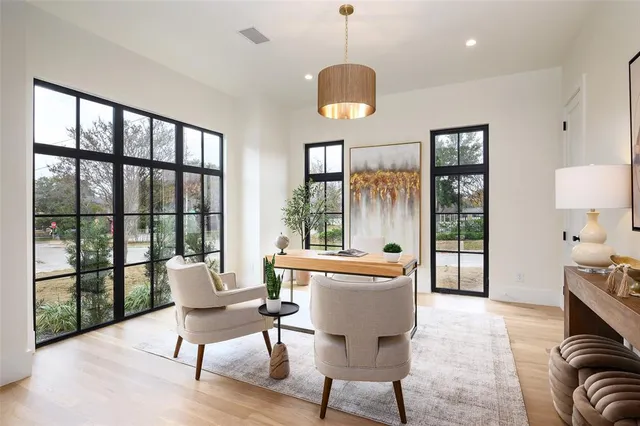 a living room with furniture a window and a chandelier