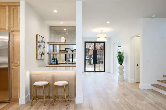a view of a kitchen area with furniture and wooden floor