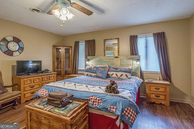 a bedroom with furniture and a flat screen tv