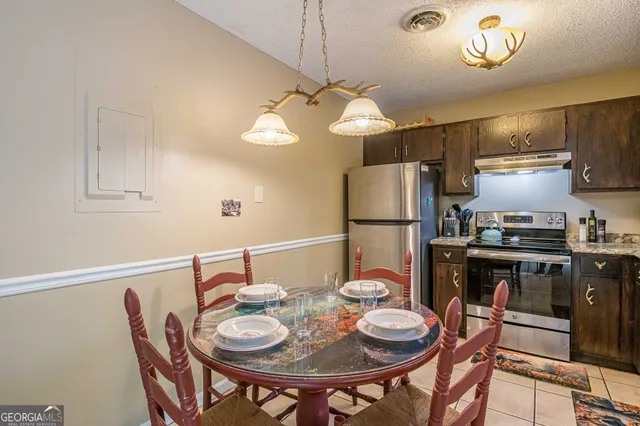 a kitchen with a dining table and chairs
