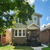 a front view of a house with a yard and porch